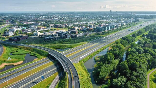 Highway junction in Almere City, Flevoland, The Netherlands. Traffic between suburban city of Almere and Amsterdam. Aerial drone hyperlapse shot.