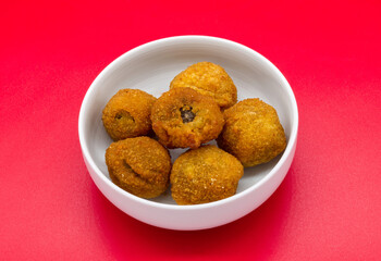 Italian Ascolane Olives, Olive Ascolane, in a bowl isolated on red background