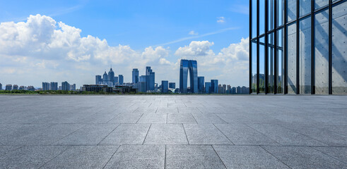 Panoramic view of city skyline and modern buildings with empty floor in Suzhou, China.