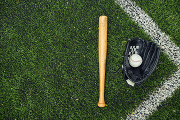 High angle view of old baseball glove, ball and bat on field for baseball game outdoors