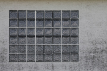 old brick glass window in the wall, concrete wall with rough surface, background with space for text