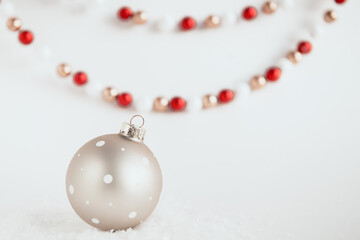 festive christmas ball on white background with snow 