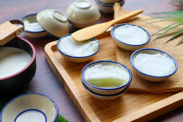Kanom Tuay - Thai dessert of steamed pandan and coconut milk in ceramic cup at close up view