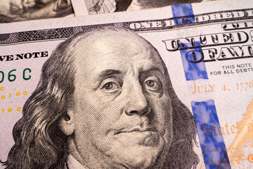 Obraz na płótnie Canvas Close-up image of Benjamin Franklin on one hundred us dollar bill