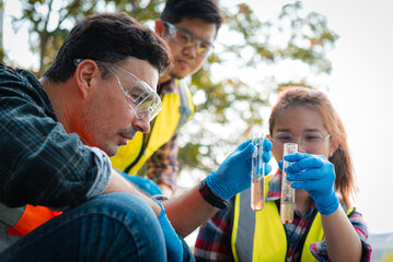 Scientists team collect water samples for analysis and research on water quality, environment with...