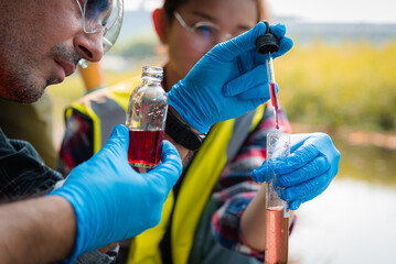 Scientists team collect water samples for analysis and research on water quality, environment with...