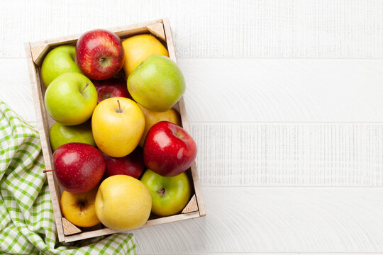 Colorful ripe apple fruits in box