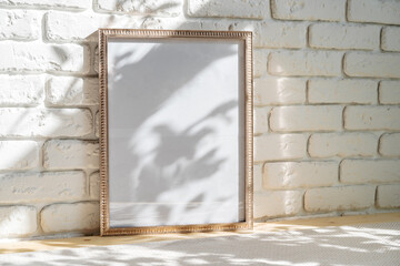 Photo frames on floor over white brick wall