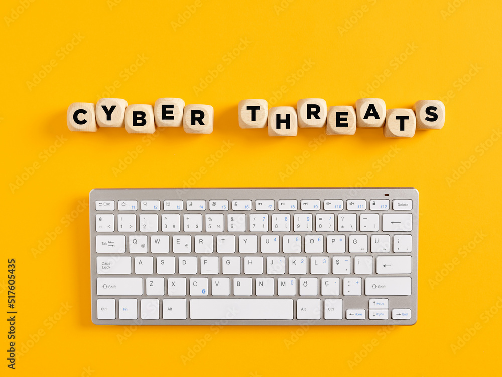Poster the word cyber threats with computer keyboard on yellow background. cyber attack and security
