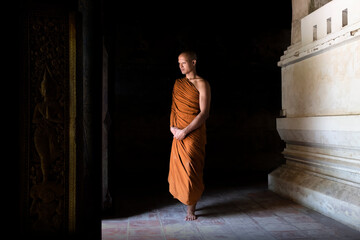 Buddhist monks walking out of the old temple