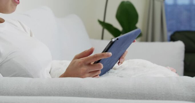 Woman hold with tablet computer and sit on sofa at home