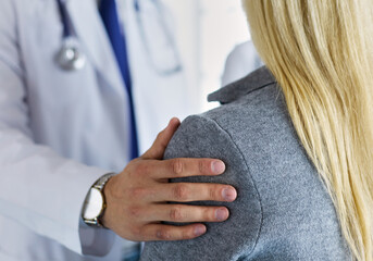 Handsome male doctor consulting a couple about infertility in his medical office