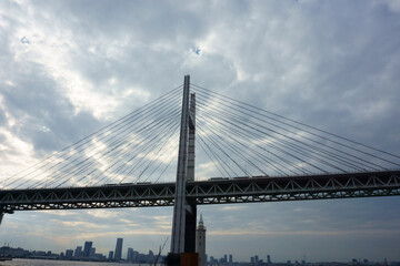 Obraz premium View of bridge against cloudy sky. Impressive Yokohama bay bridge over Tokyo Bay