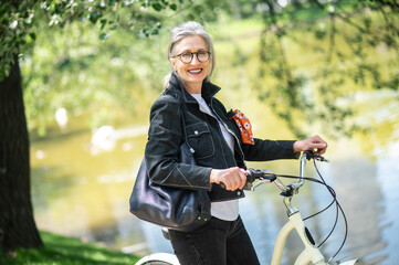 Fototapeta na wymiar A woman in black jacket on a bike