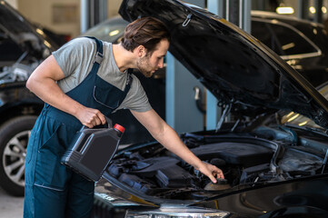 Technician in the care service changing engine oil