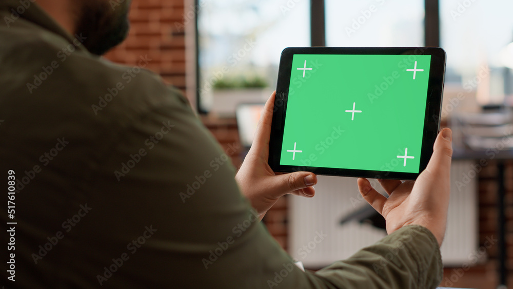 Aufkleber office worker holding horizontal greenscreen on tablet, analyzing chroma key display with isolated m