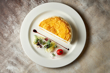 A tall egg omelet with lettuce on a white plate. Selective focus. Noise in post-production