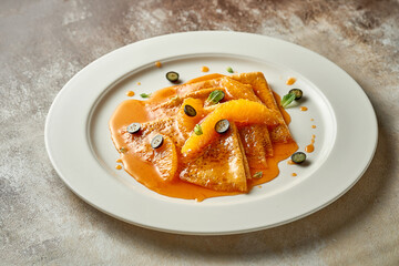 Pancakes or crepes with orange jam. Selective Focus. Noise in post-production