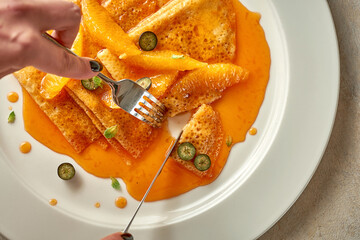 Pancakes or crepes with orange jam. Selective Focus. Noise in post-production