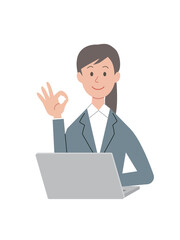 パソコン操作をするOKサインのビジネスウーマン