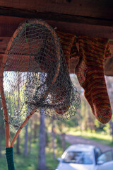 fly landing net and warm socks drying after successful fishing on the river