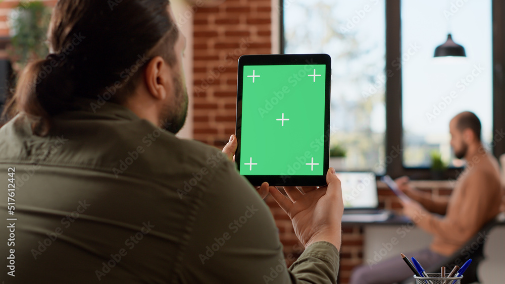 Poster office worker analyzing greenscreen template on digital tablet, working on business with isolated ch