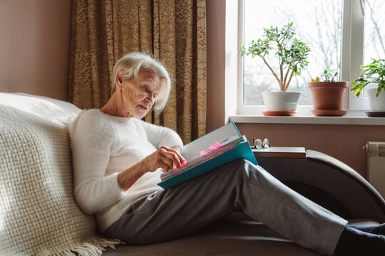 Senior woman reading documents at home