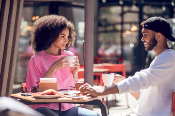 Cute young couple having coffee in the cafe