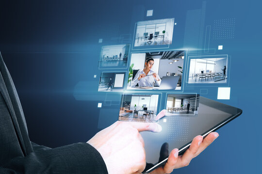 Close up of businessman hand pointing at tablet with creative digital picture gallery on blue background. Photo album and media technology concept. Switching images.