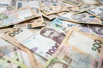 Obraz na płótnie Canvas banking and finance banknotes of 500 1000 Ukrainian hryvnia as background