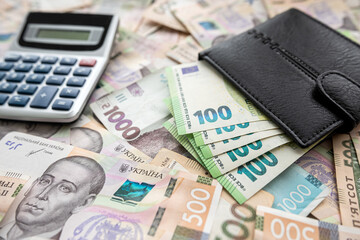 exchange concept euro bills in purse with calculator lying on euro banknotes background