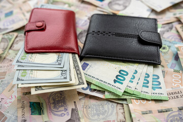 Money 100 dollars and  100 euros in wallet vs 500 1000 ukrainian hryvnia. exchange concept