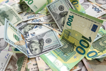 Fototapeta na wymiar set of hryvnia dollar and euro banknotes as business background. Money saving concept