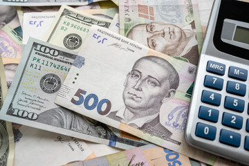 Fototapeta premium paper money Ukraine with dollar and calculator