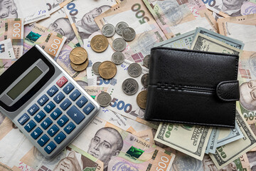 ukraine money hryvnia with us dollar bills with purse on desk