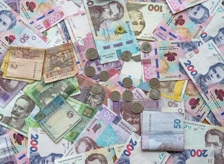 Ukraine money coins lying on  mixed hryvnia banknotes, background
