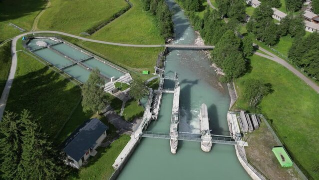 Aerial view on hydro dam. Power plant on mountain river with clean water 