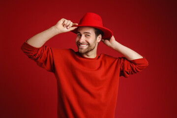 Young white man wearing hut smiling and looking at camera