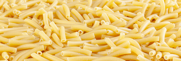 Background witn raw italian maccheroni pasta