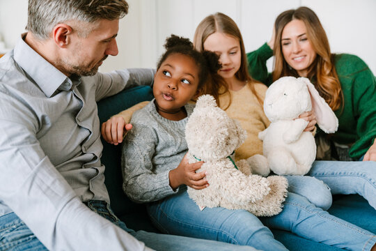 Happy family with adopted african little girl