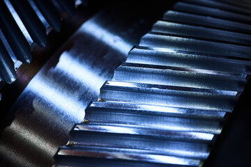Metal cogwheels of spiral gear drive in plant workshop