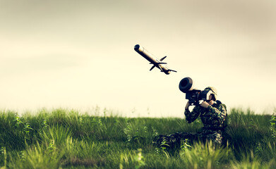 Naklejka na ściany i meble Soldier firing anti-tank missile at war