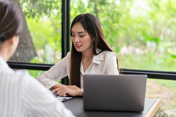Coworker business concept, Two businesswoman discussing and calculating cost of business project