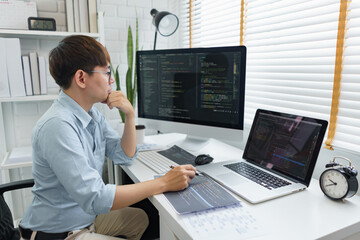 Software development concept, Male programmer read data code to thinking about developing website