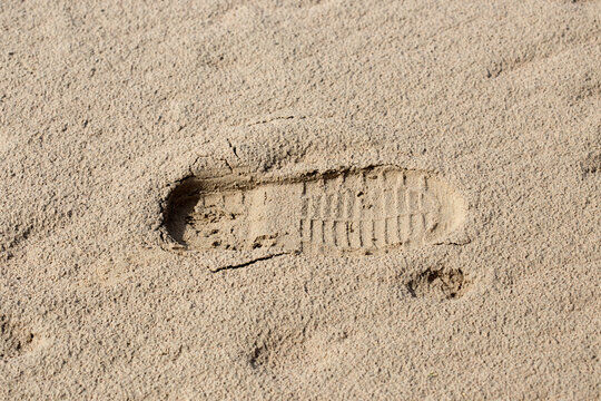 footprints of men's shoes in the sand