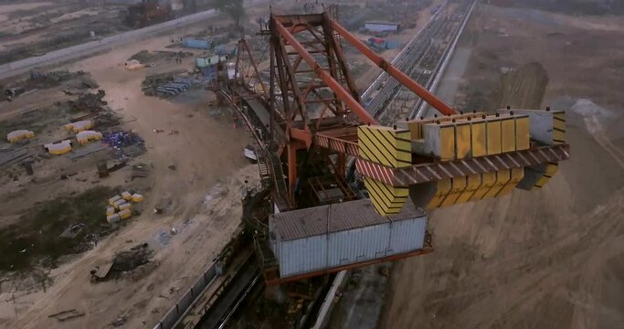 Combined Stacker And Reclaimer For Bulk Material Handling At Paradip Port In India. - aerial, pullback