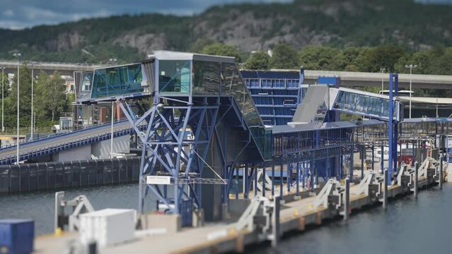 Passenger terminal in the Kristiansand port. A busy road in the background. Slow-motion, pan follow.