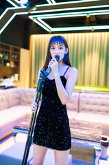 Girls in sexy black slip dresses sing at KTV