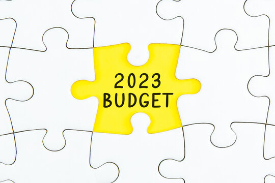 Business concept - 2023 BUDGET word on a jigsaw puzzle background.