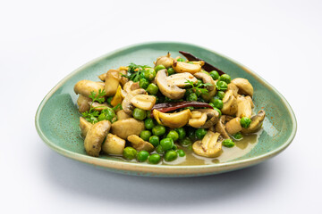 Mushroom and Pea Curry with Roasted Garlic, Indian food served in a bowl